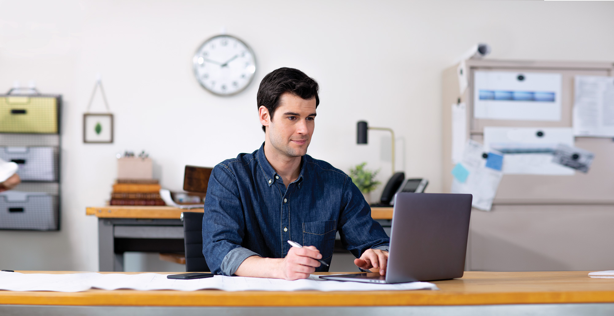Cox Business Man at Laptop taking notes