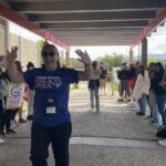 Brandy Goodson walking through "high-five tunnel" at Earl Wooster High School